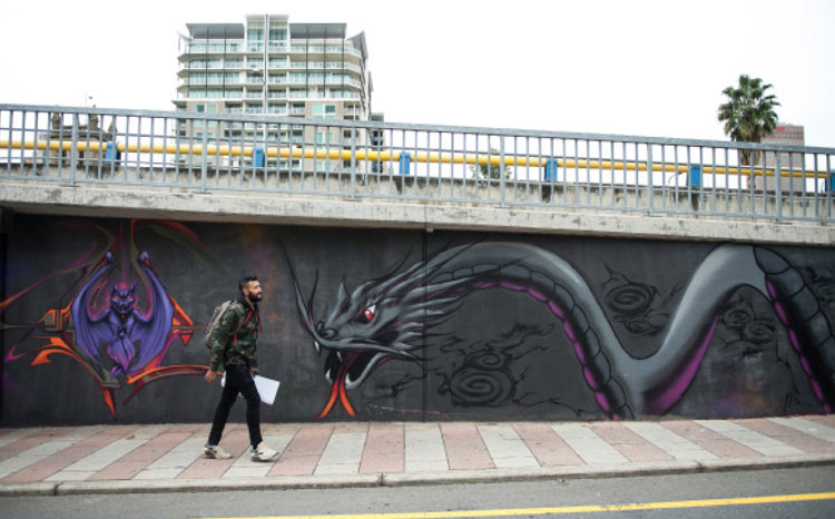 Graffiti artist Jack Franceschini paints messages of hope under one of the busiest bridges in Adelaide, Australia. Photo by Robert Johnson